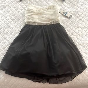 Size 9.  Short black/white formal dress with diamond and pearl sequins waist